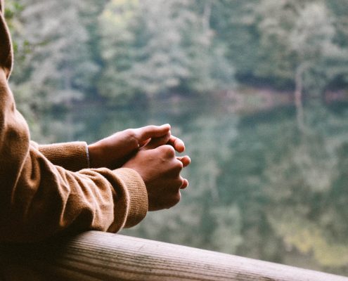 person looking over lake