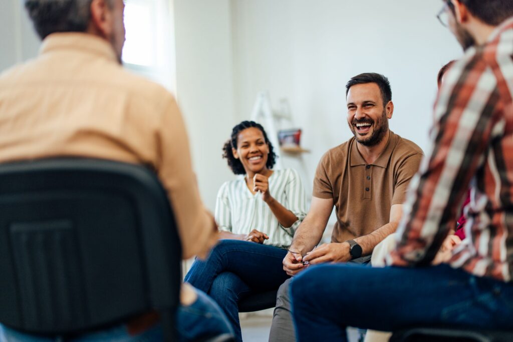 A group of people talking at a support group for substance use.