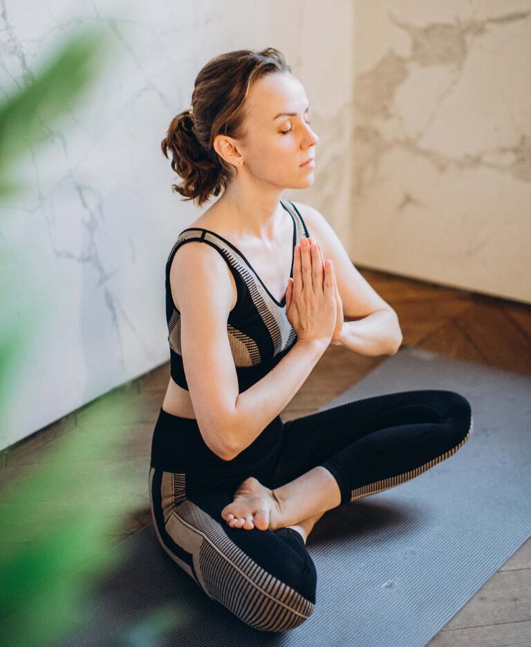 Woman practicing mindfulness meditation and doing yoga