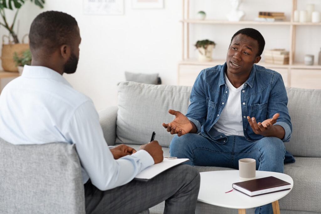 A young African American man in a therapy session.