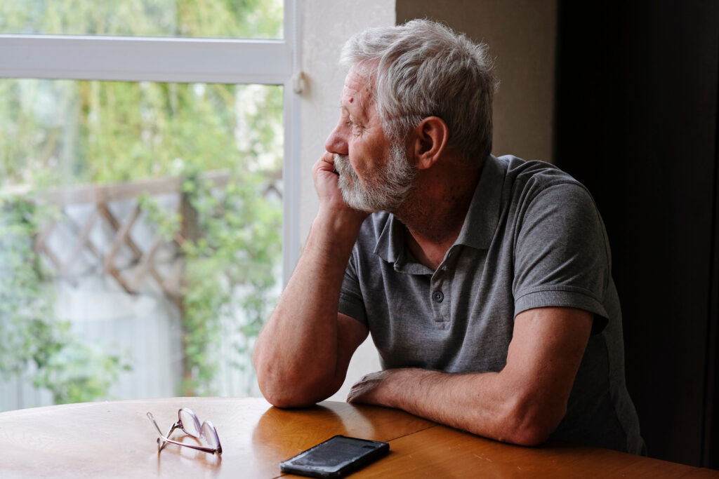 Older man sitting alone