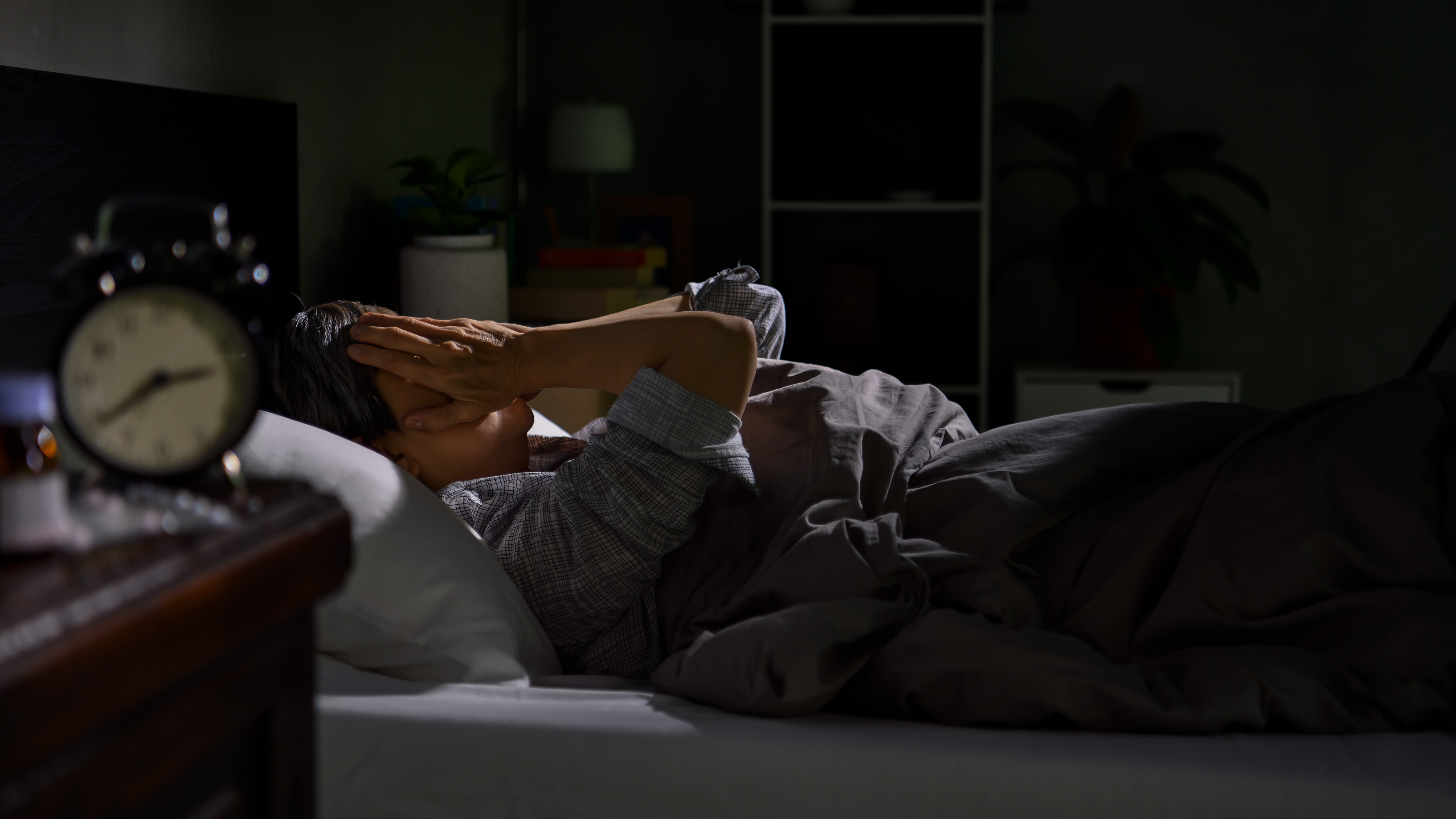 Woman lying in bed with insomnia