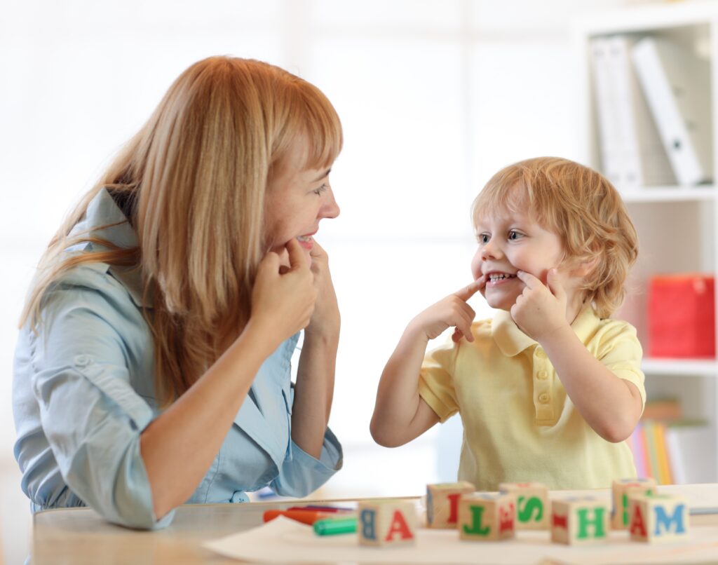 A therapist plays with a young child.