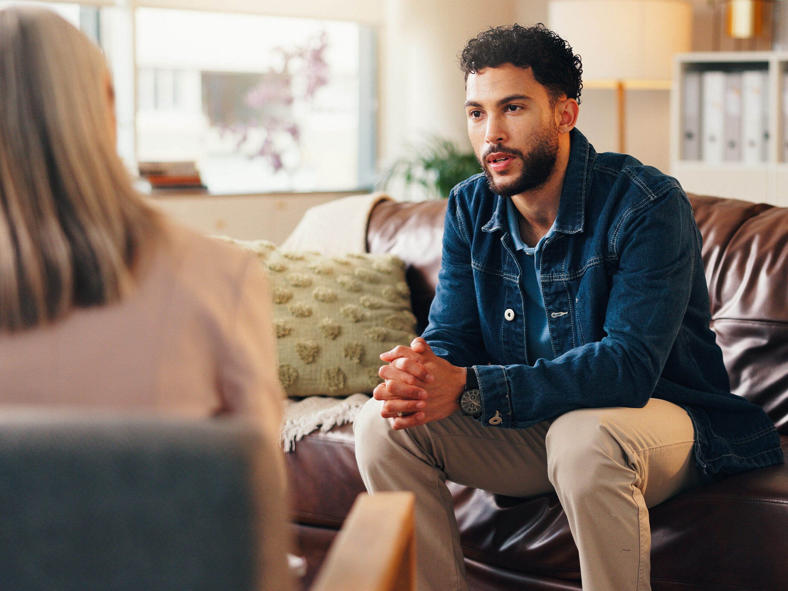 A male patient in a CBT therapy session.