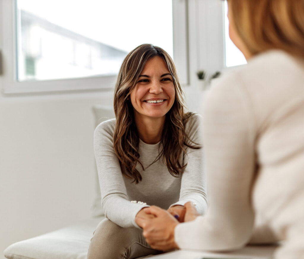 A smiling woman in a therapy appointment.